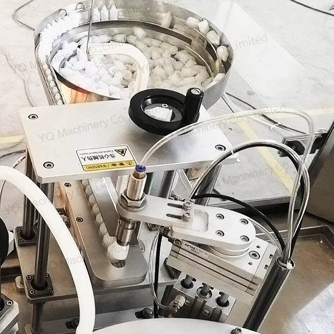 Vial filling and capping machine with peristaltic pump metering system Vial filling and capping machine with peristaltic pump metering system