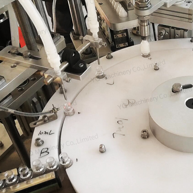 Vial filling and capping machine with peristaltic pump metering system Vial filling and capping machine with peristaltic pump metering system