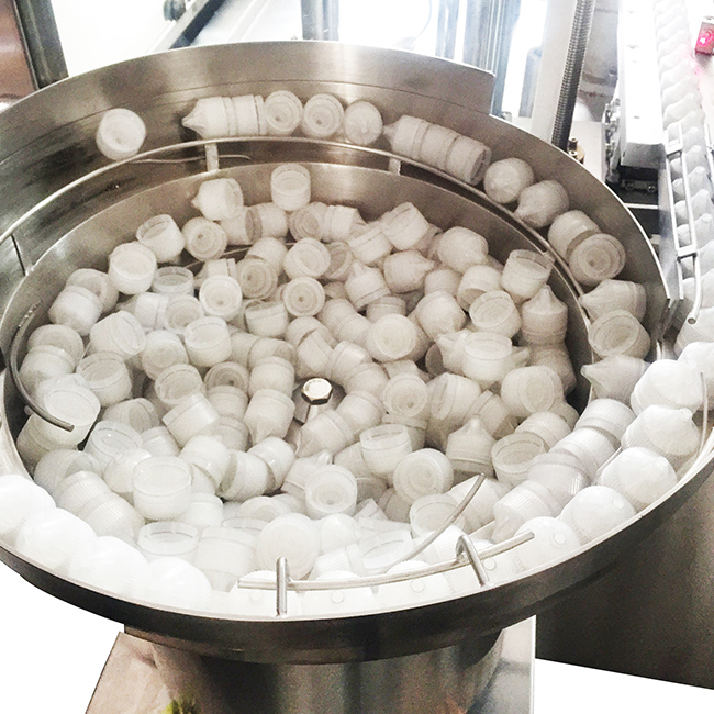 Vial filling and capping machine with peristaltic pump metering system Vial filling and capping machine with peristaltic pump metering system